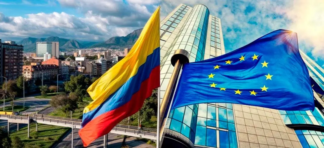 Bandera de Colombia y bandera de la Unión Europea ondeando frente a un edificio moderno